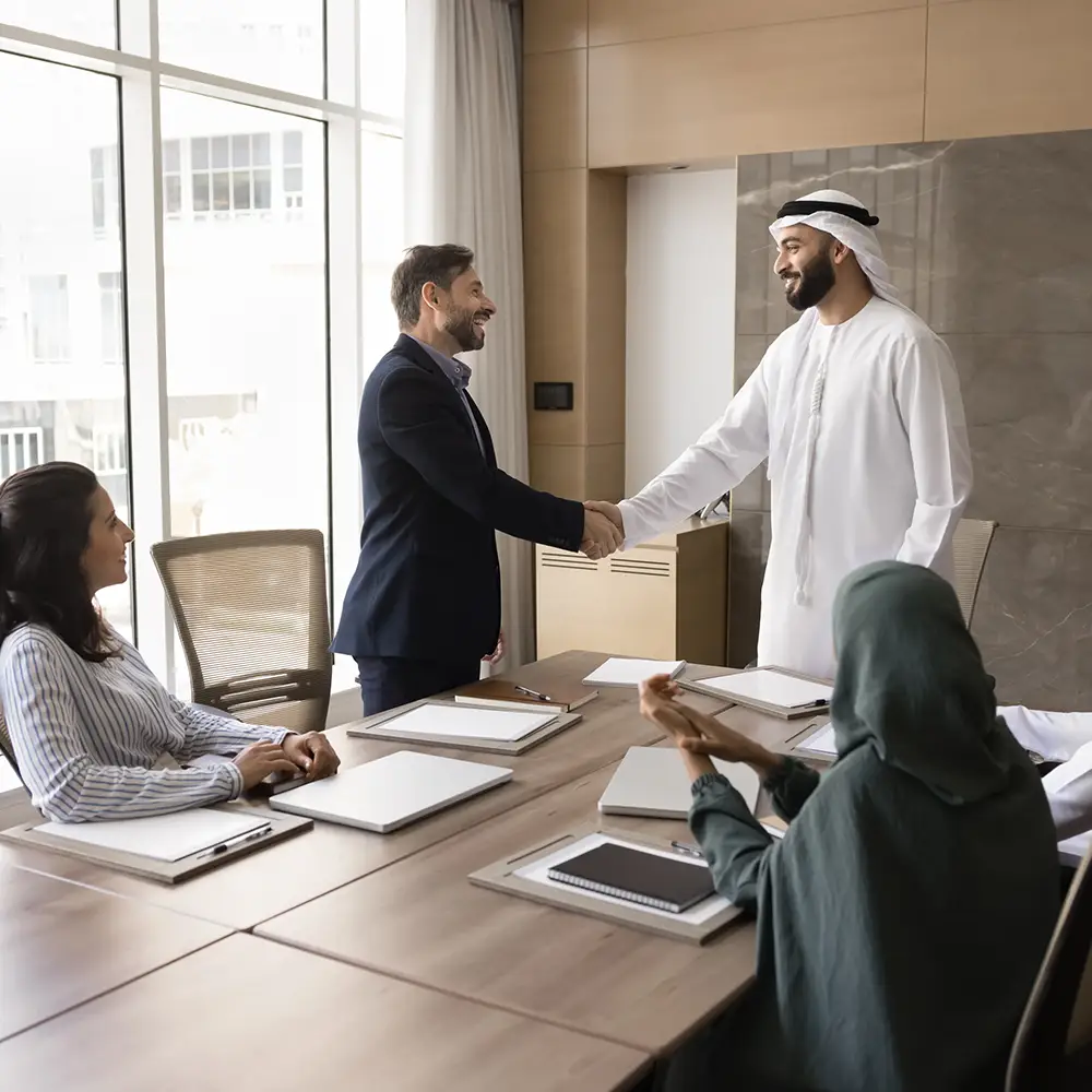 UAE business leaders meeting and shaking hands during a corporate financing discussion