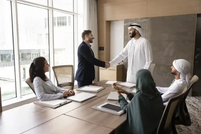 UAE business leaders meeting and shaking hands during a corporate financing discussion